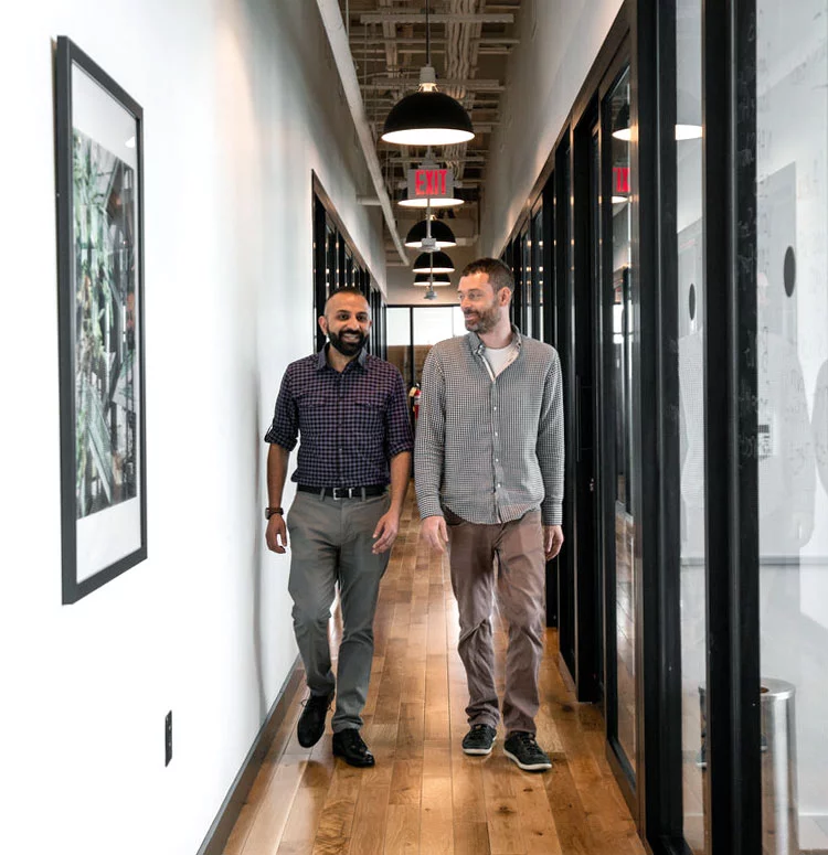 Malik Soomar and John McGhee walking through the Webconsuls office